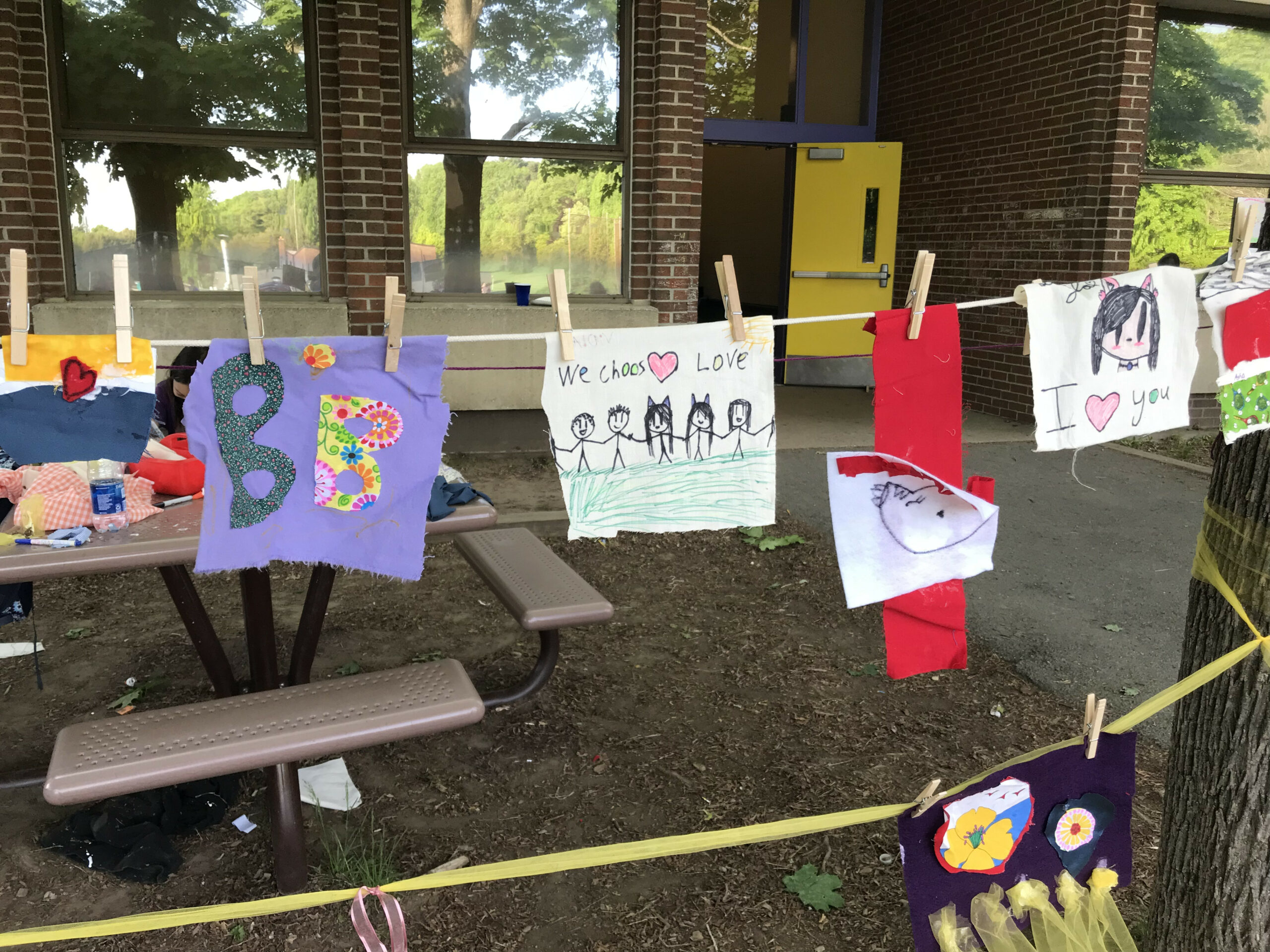 Image of children's drawings on a clothesline